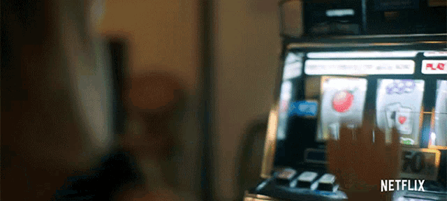 a person is playing a slot machine with a netflix logo in the background