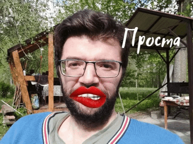 a man with glasses and red lipstick on his lips is standing in front of a sign that says prost