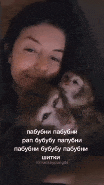 a woman is holding two monkeys with a caption that says " monkeypongifs "