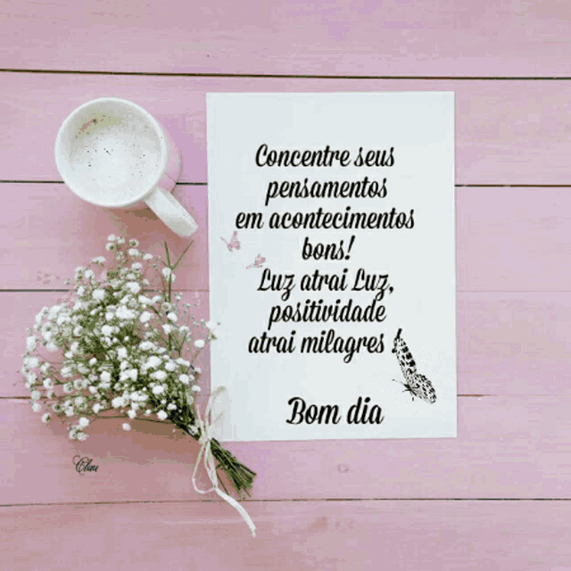 a bouquet of baby 's breath sits on a pink table next to a cup of coffee