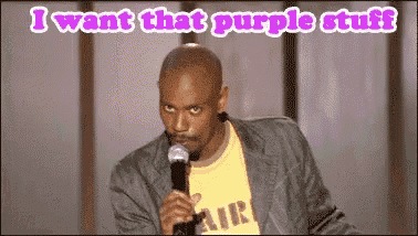 a man holding a microphone with the words " i want that purple stuff " above him