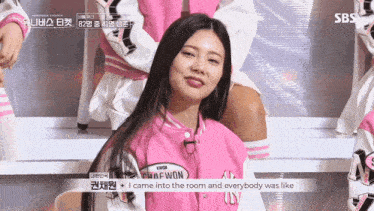 a girl in a pink jacket with the word won on it