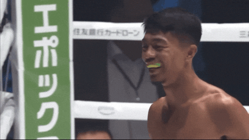 a man in a boxing ring with a green sign in the background that says epoch
