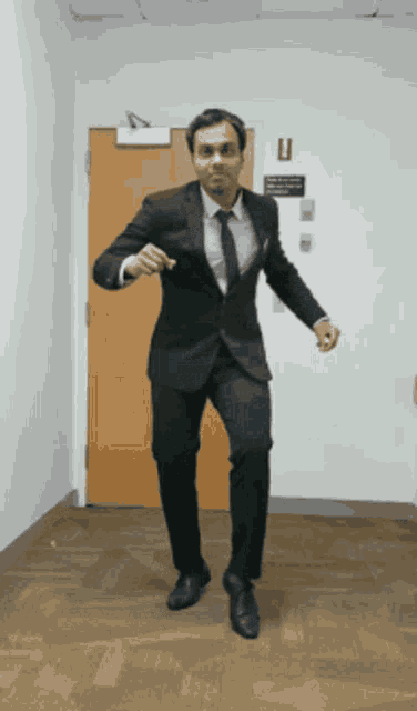 a man in a suit and tie is dancing