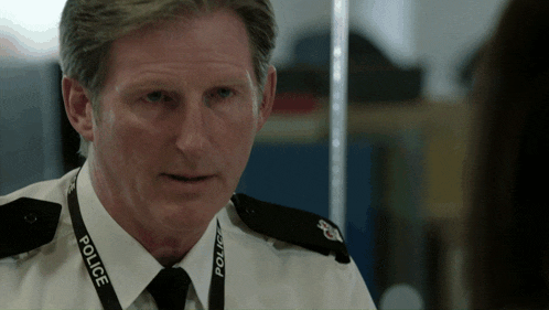 a man in a police uniform has a lanyard around his neck that says police