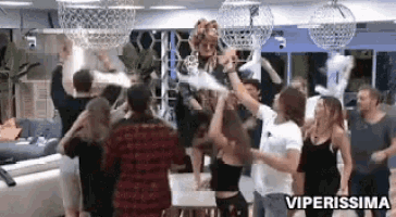 a group of people are dancing in a room with the words viperissima written on the bottom .