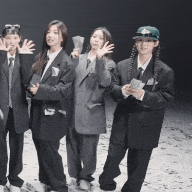 a group of girls in suits and ties are posing for a photo
