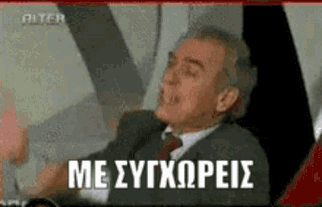 a man in a suit and tie is speaking in a foreign language