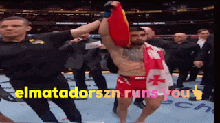 a man holding a flag in a boxing ring with the words " elmatadorszn runs you " above him
