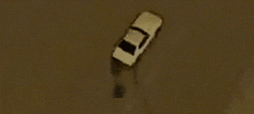 an aerial view of a car driving down a road .
