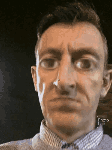 a close up of a man 's face with a photo lab watermark in the corner