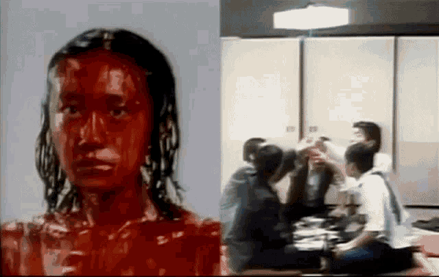 a woman with red paint on her face is next to a group of people sitting at a table