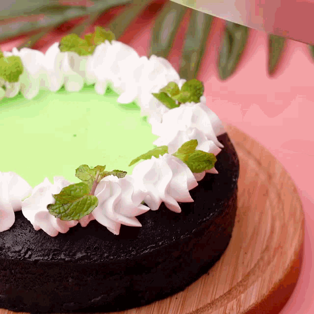 a chocolate cake with green frosting and white frosting
