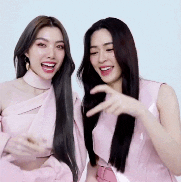 two women are standing next to each other and smiling .