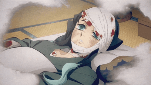 a man with a bandage on his head is laying on a bed