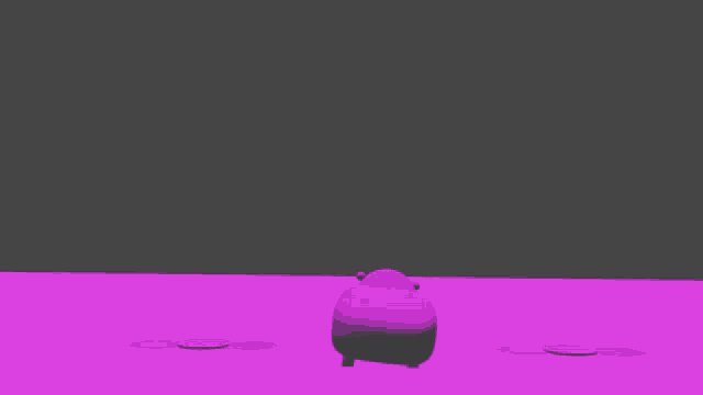a purple object is sitting on a pink surface next to a black object .