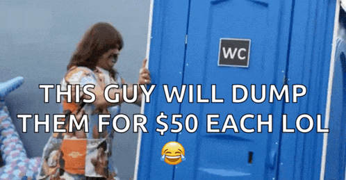 a woman stands in front of a blue portable toilet that says wc