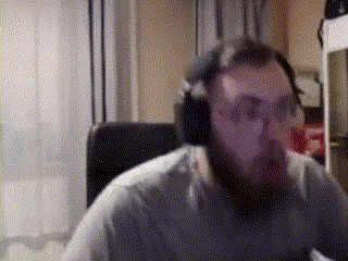 a man with a beard wearing headphones and glasses