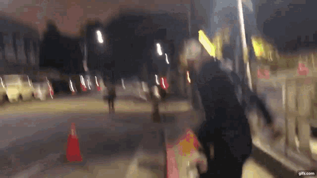 a blurry image of a person walking down a street at night