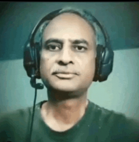 a man wearing headphones with a microphone on his head .