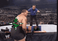 a man in a wrestling ring with the letter w on the bottom