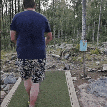 a man is walking on a path with a sign that says 10