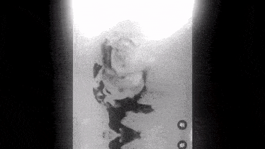 a black and white photo of a person laying in a bathtub .