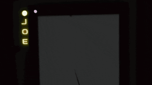 a bunch of smiley faces are sitting around a table in a dark room