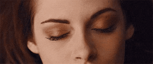 a close up of a woman 's face with her eyes closed and her eyebrows visible .