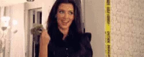 a woman is standing in a room with a yellow caution tape on the wall .