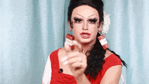 a woman in a red dress is holding a box of cigarettes
