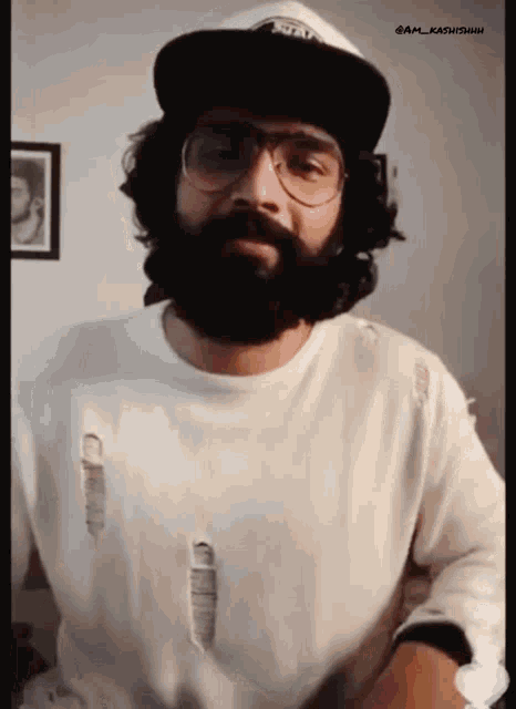 a man with a beard wearing glasses and a hat that says " stay "