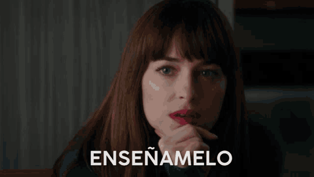 a woman with her eyes closed and the word enseñamelo written on the bottom