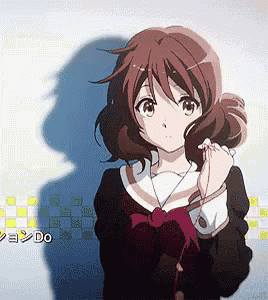 a girl in a school uniform is standing in front of a wall with the word do written on it