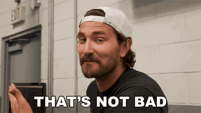 a man with a beard wearing a white hat says that 's not bad