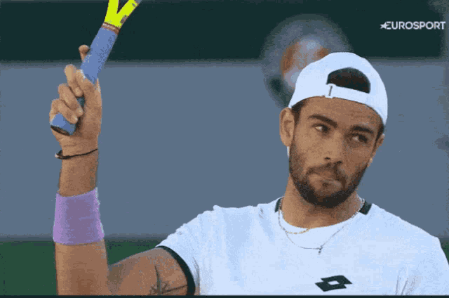 a man holding a tennis racquet with eurosport written on the bottom right