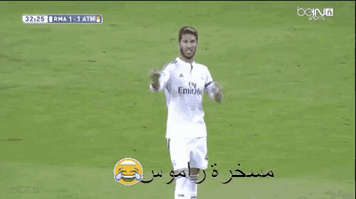 a soccer player wearing a fly emirates jersey stands on the field