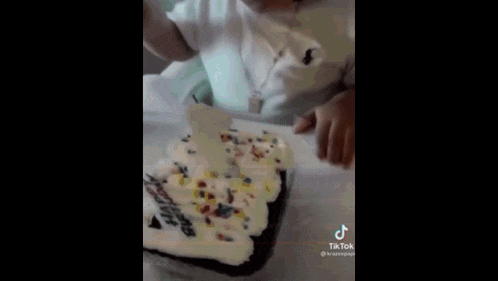 a baby is sitting in a high chair with a knife in his hand .