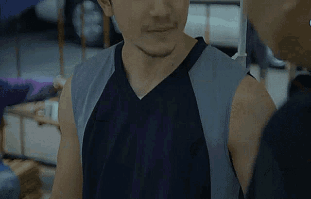 a man with a beard wearing a black tank top
