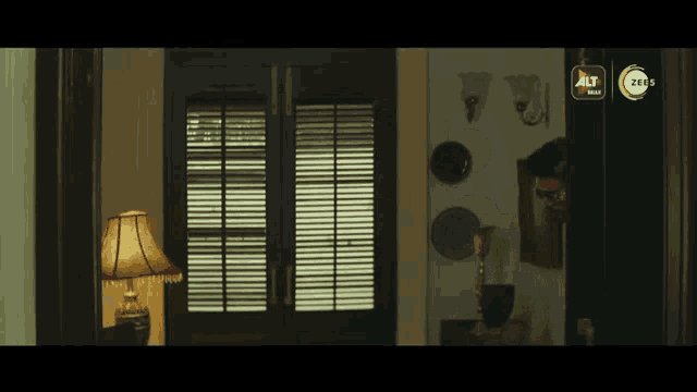 a room with a lamp and a sign that says alt