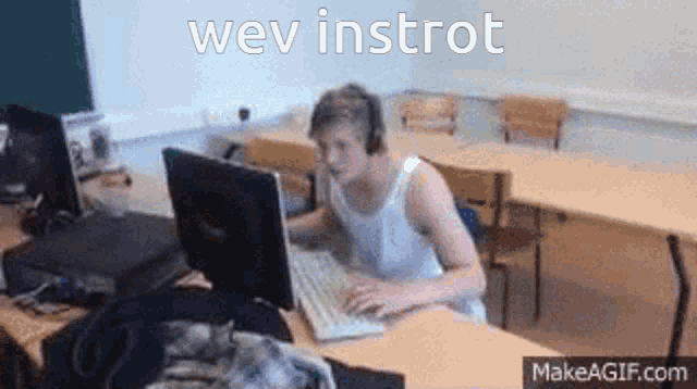 a man is sitting at a desk in front of a computer with the words wev instrot written above him .
