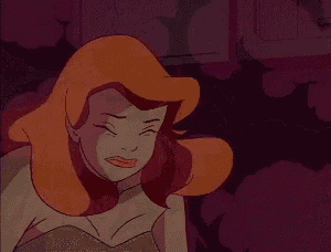 a close up of a cartoon character with red hair and a green dress .