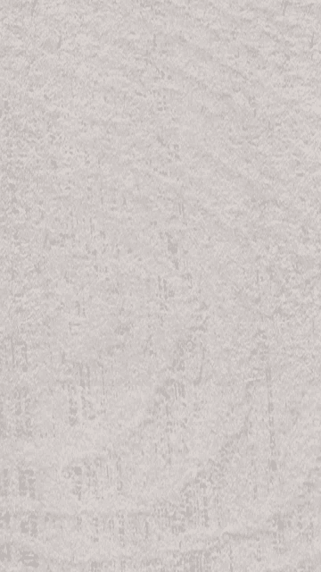 a close up of a piece of paper with a gray texture