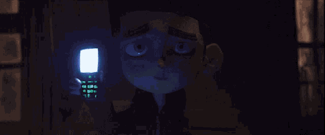 a cartoon character is holding a cell phone with a green screen