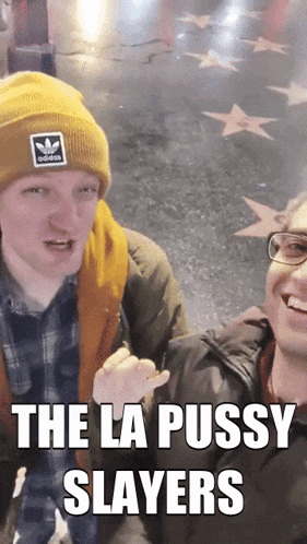 a man wearing a yellow adidas beanie is standing next to another man