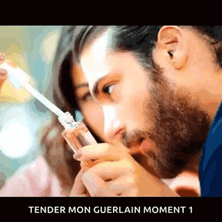 a man is holding a bottle of perfume next to a woman and the words tender mon guerlain moment 1