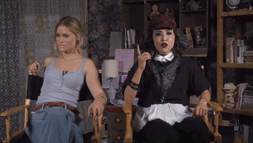 two women sitting next to each other with one wearing a hat that says ' i love you '