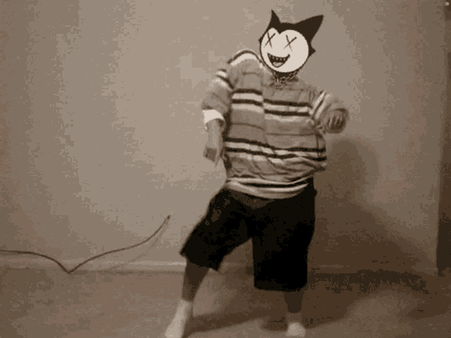 a man is dancing with a dead cat on his face