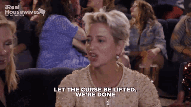 a woman says " let the curse be lifted we 're done " in front of a crowd