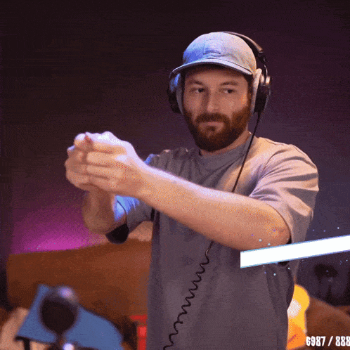 a man wearing headphones and a hat with the number 987 / 888 on the bottom